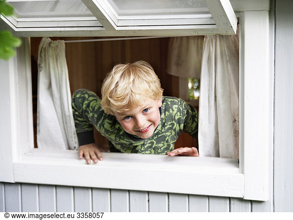Boy playing in window