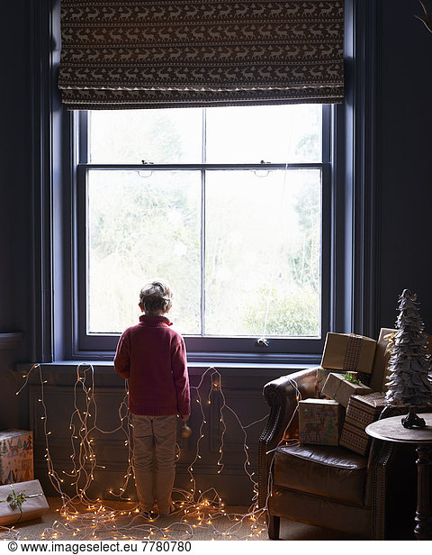 Boy playing with Christmas lights