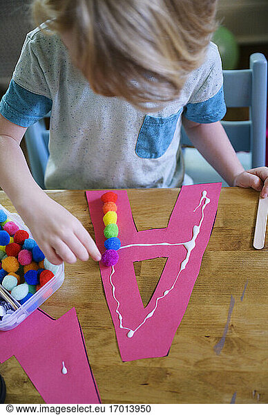 Boy (4-5) preparing paper cutout