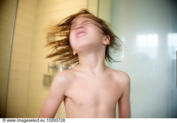 Boy shaking wet hair