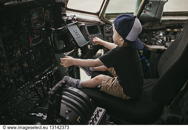 Boy sitting in cockpit