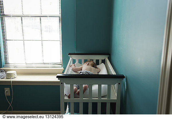 Boy sleeping in bunkbed at home