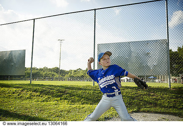Boy throwing ball while playing baseball