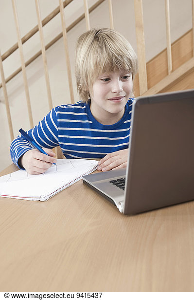 Boy using laptop for doing his homework