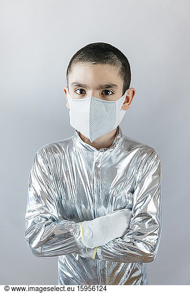 Boy wearing space suit and protective mask