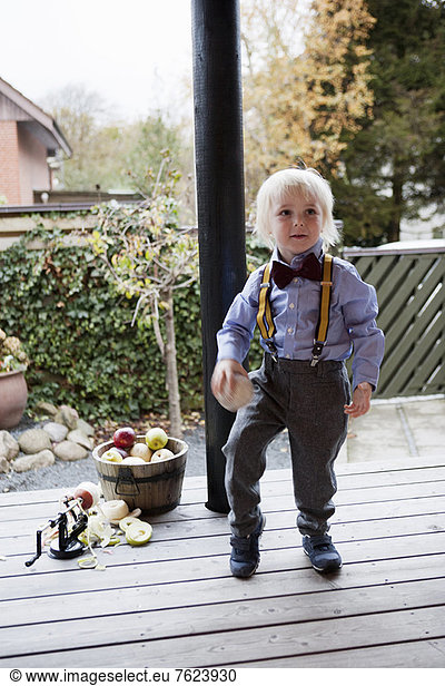 Boy wearing suspenders and bow tie