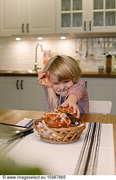 Boy with dessert on dining table at home
