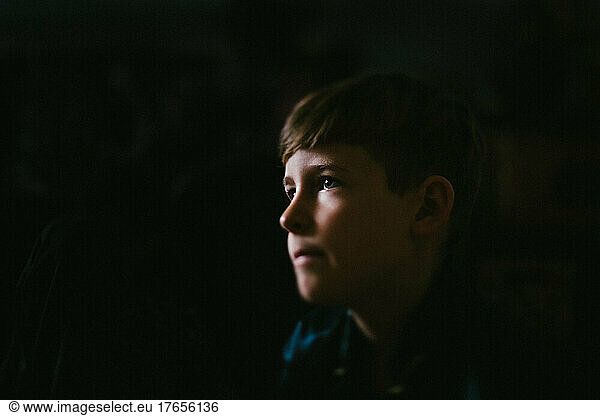 Boy with dramatic light on face and in eyes