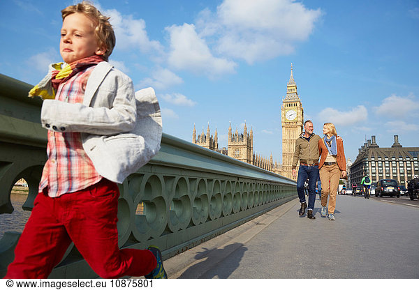 Boy with family running across westminster bridge