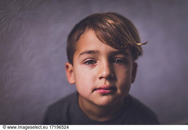 Boy with hazel eyes looking at the camera.