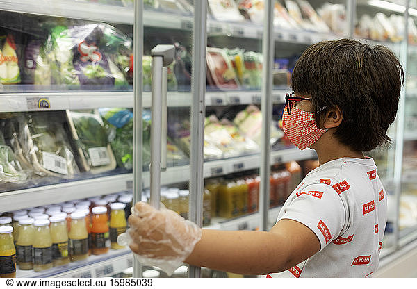 Boy with mask in supermarket