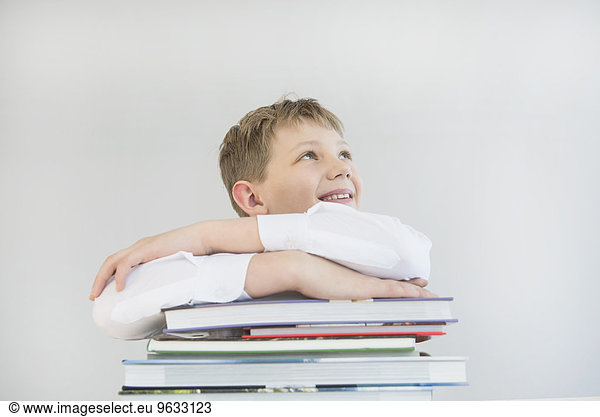 Boy with stack of books  smiling