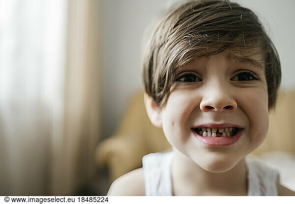 Boy with tooth gap at home