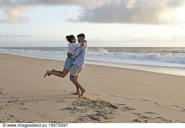 Boyfriend and girlfriend enjoying together at beach
