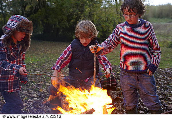 Boys building bonfire outdoors