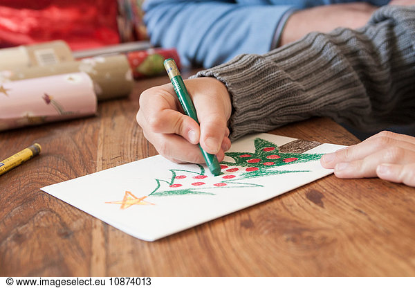 Boys hand drawing christmas tree