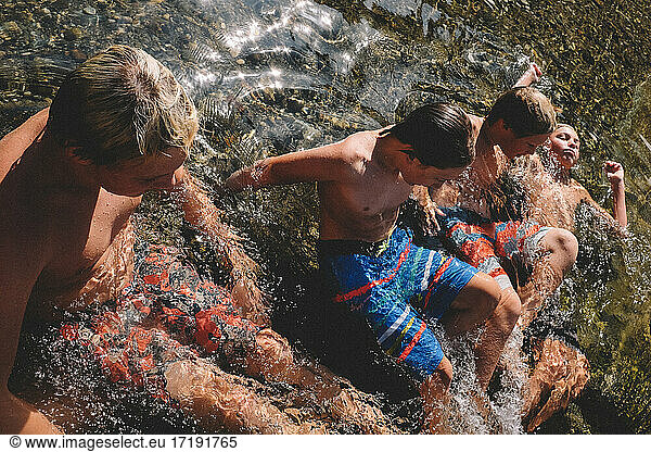 Boys laying the California Sun wearing Colorful Swim Trunks