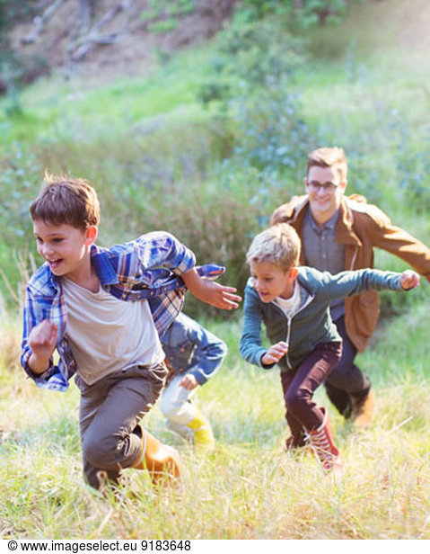 Boys running in field