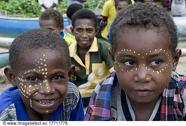 Boys with face paint on the shore of Siboma Village  Lababia Island  Huon Gulf  Morobe Province  Papua New Guinea; Siboma Village  Morobe Province  Papua New Guinea