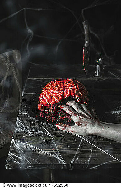 Brain cake for Halloween party with zombie hand