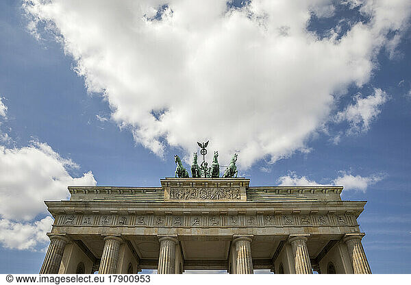 Brandenburg Gate under cloudy sky on sunny day at Berlin  Germany