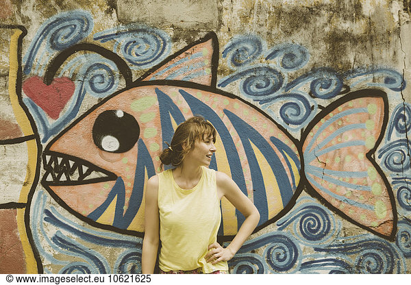 Brazil  Rio de Janeiro  tourist standing in front of wall painting