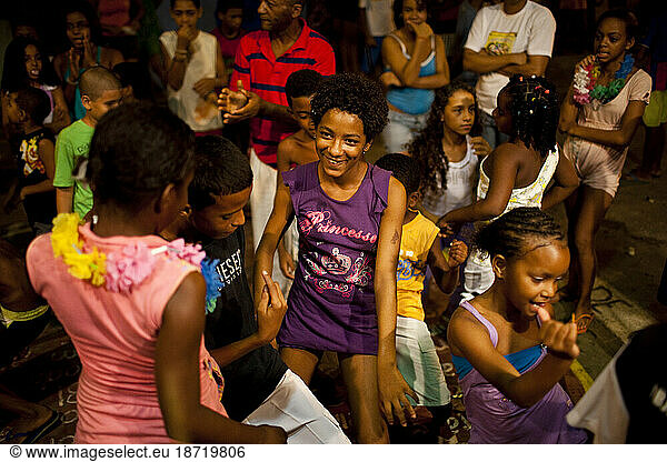 Brazilian children dance in the street following a capoeira roda in one of Salvador's favelas  Brazil.