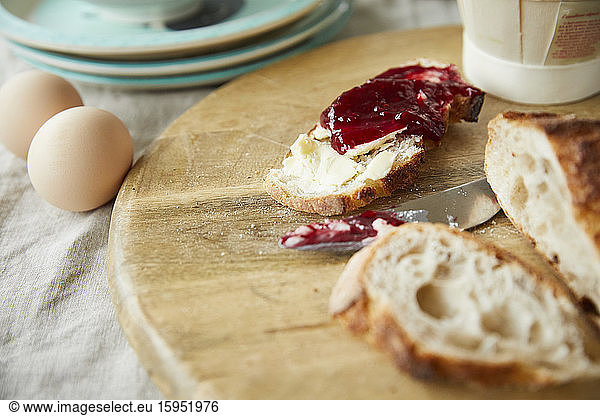 Bread with jam on wooden board