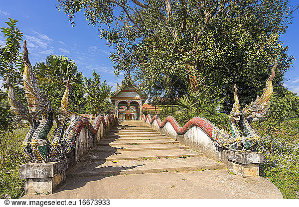Bridge decorated with statues of dragons leading towards Buddhist shrine  Luang Namtha Province  Laos
