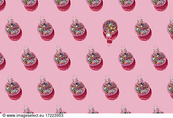 Bright balls for Christmas tree pattern on pink background
