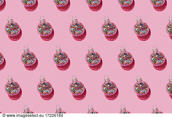 Bright balls for Christmas tree pattern on pink background