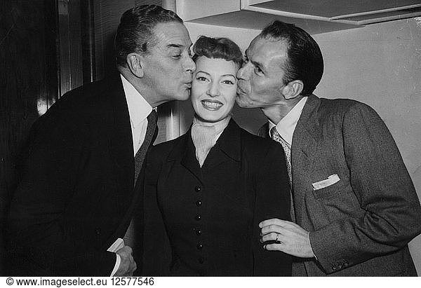 British actress Jean Carson gets a kiss from Frank Sinatra and Jack Buchanan  London  1953. Artist: Unknown