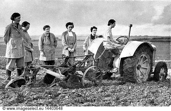 British girls of the Women"s Land Army learning to plough with a tractor. World War II