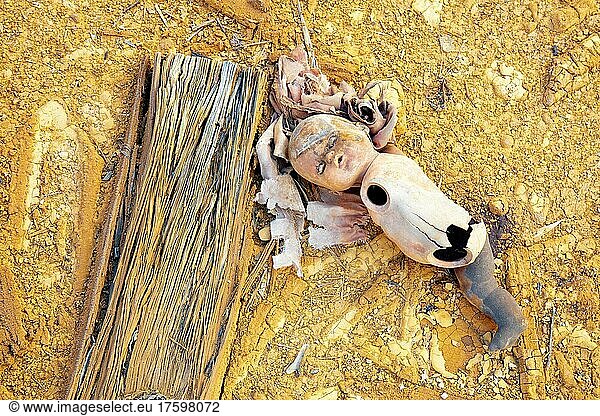 Broken doll lying on bank of Rio Tinto river