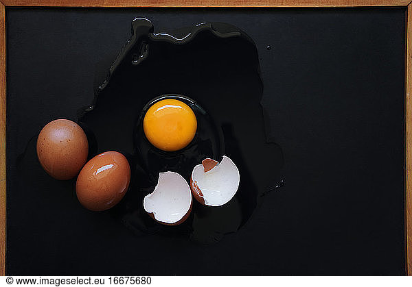 Broken egg on the black floor
