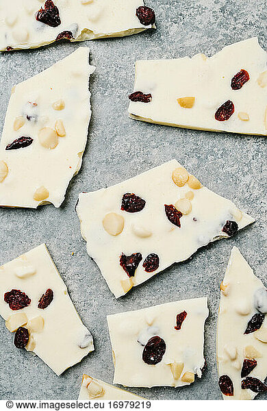 Broken pieces of white chocolate bark with cranberry and macadamia nut