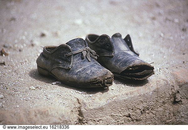 Broken shoes on beach