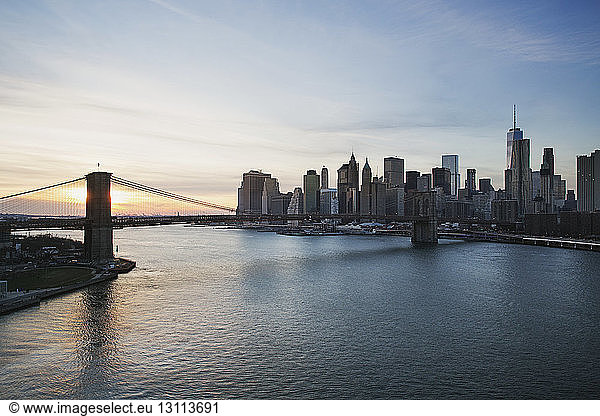 Brooklyn Bridge over East River during sunset