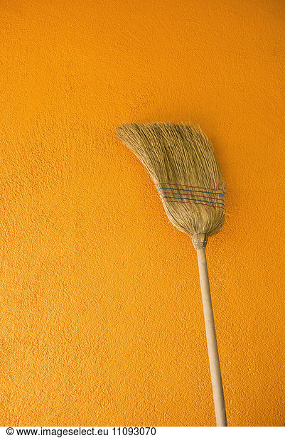 Broom leaning against yellow wall  Austria