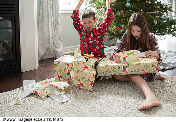 Brother and sister opening christmas presents