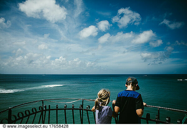 Brother and Sister overlook gorgeous blue sky and ocean
