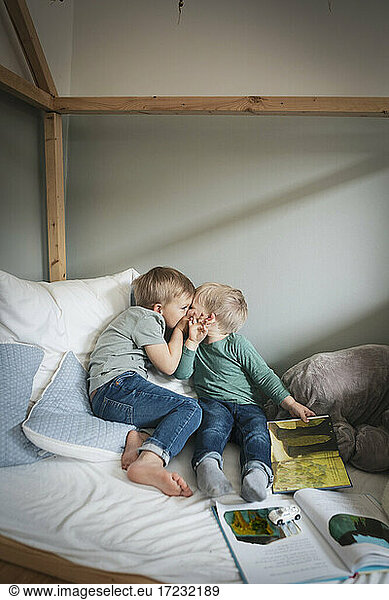 Brothers kissing each other in bedroom