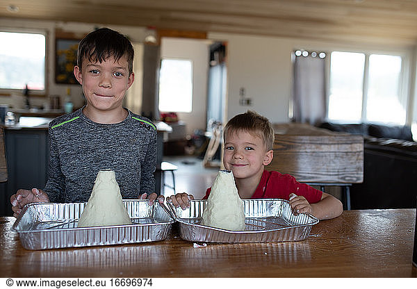 Brothers standing proud with their homemade volcanos