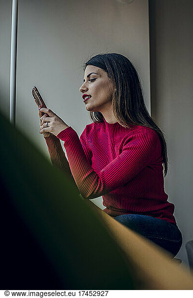 Brunette woman checking her mobile phone