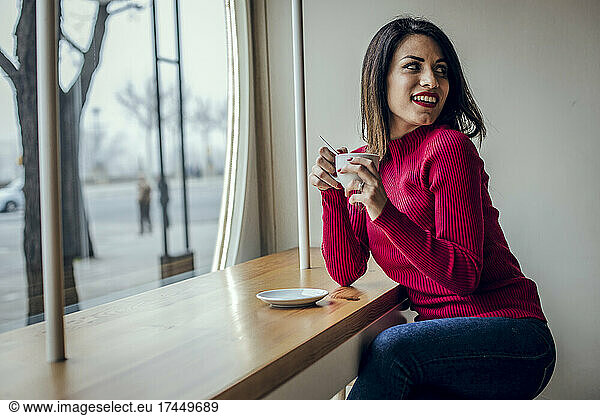 Brunette woman having a coffee