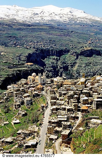 Bsharri village with view of snowcapped Lebanese Mountains  Lebanon