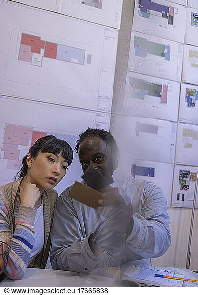Building designers looking at swatches in office meeting
