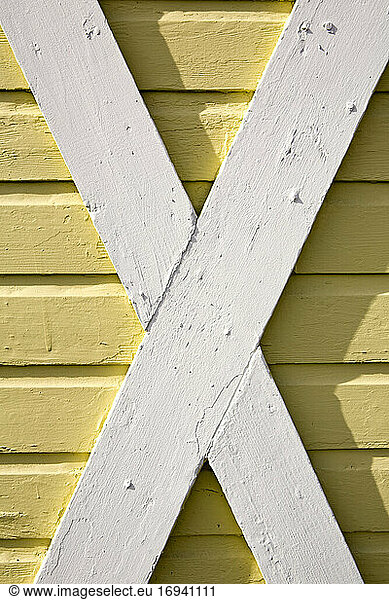 Building exterior  wood cladding  cross beams  white and yellow woodwork
