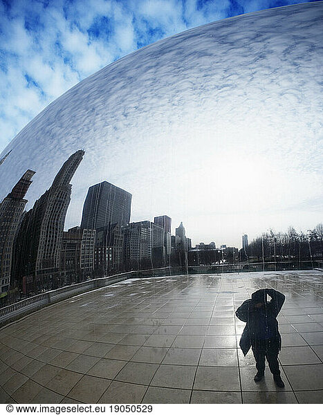 Buildings and sky reflected in the Cloud Gate sculpture  Chicago  IL.