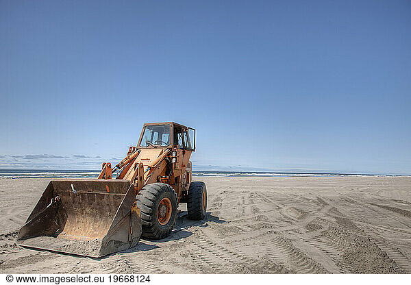 Bulldozer on sandy beach.